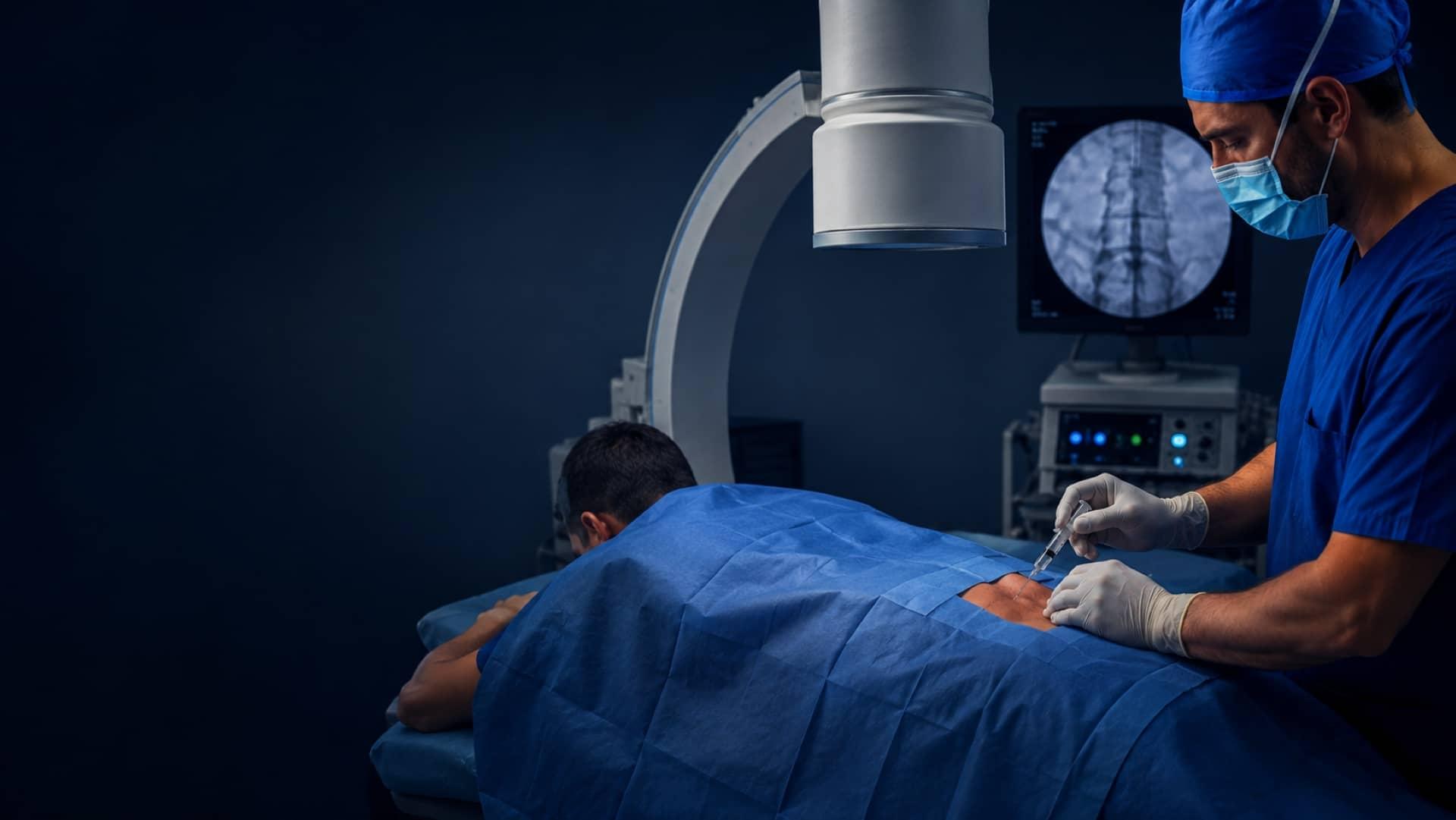 A pain specialist performing a fluoroscopy-guided medial branch block